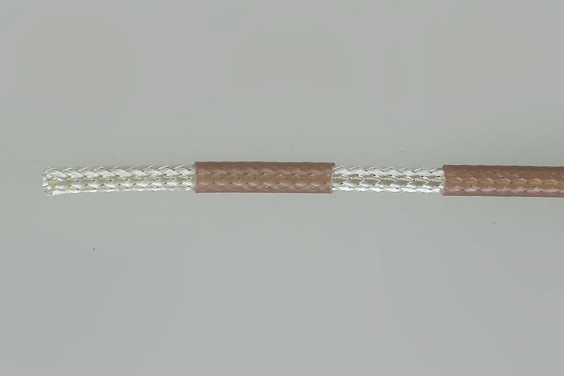 Silver wire inside wrapper of brown color.